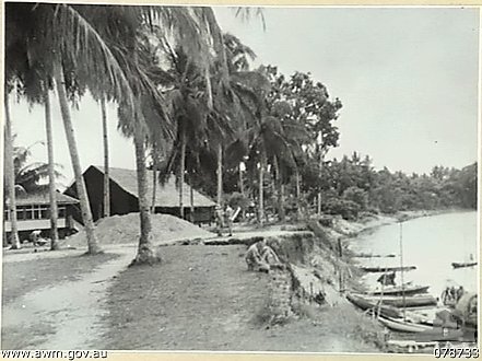 The Kota Bharu riverbank in 1941: timber buildings and praus moored under the palms